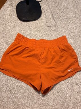Nike Orange Athletic Shorts with White Swoosh